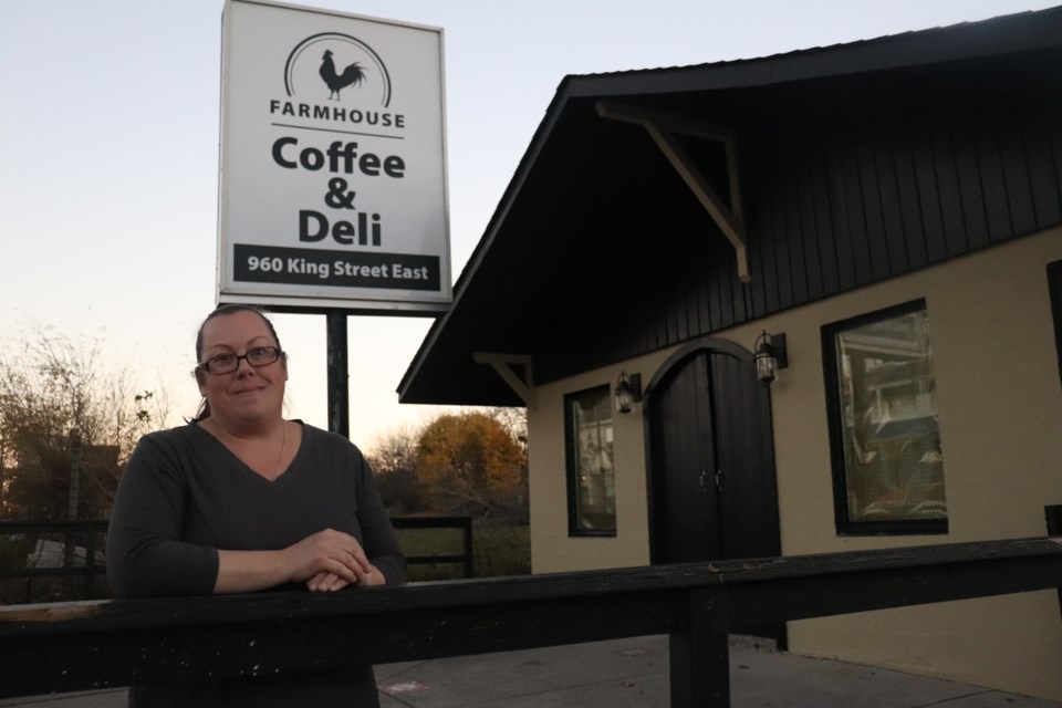 Leslie Zinger stands in front of the newly installed sign for her upcoming cafe in Preston.
