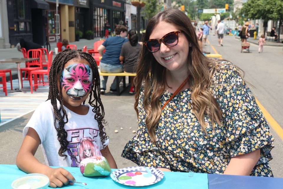 The Morrison Family paints rocks after stopping at the face painting booth.