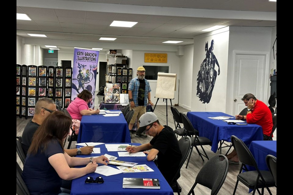 Keith Grawcho teaches a room full of aspiring comic creators at the Hero's Tale in Preston