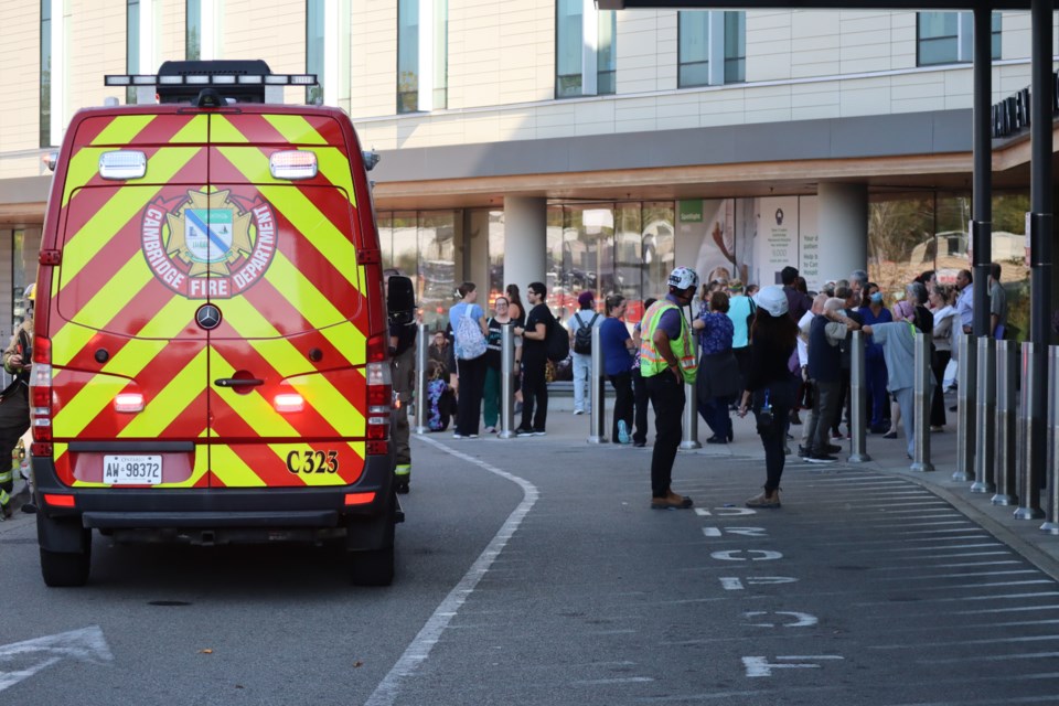 Fire crews talk with hospital staff while patients are evacuated from the hospital