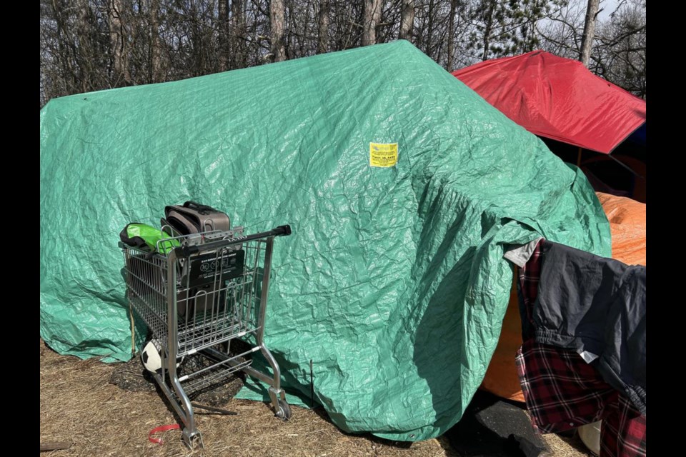 Tents and structures at the Banchton Road encampment were left with notices to warn residents to vacate or have their belongings destroyed.
