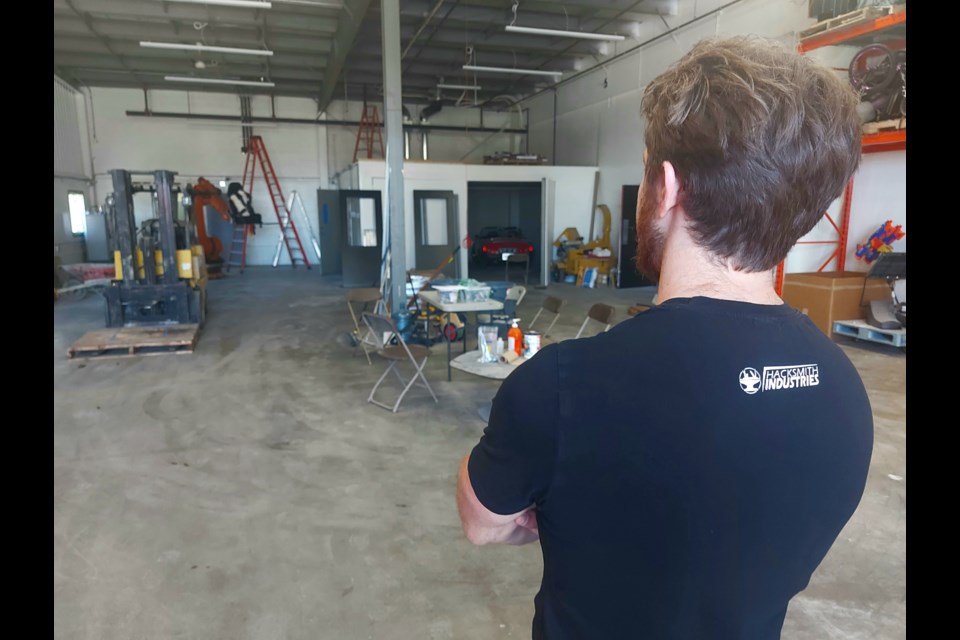 James Hobson, also known as The Hacksmith, stands inside the new shop space where they will create real life items from comic books and movies.