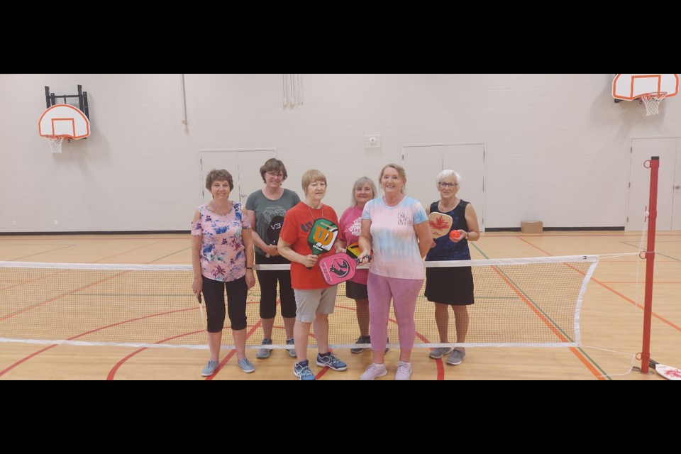 Dawn Nickless, Nanci Womersley, Nicole Powell, Valerie Beadle, Leila Stairs, a church volunteer and organizer, Lois Kerr play pickleball in Cambridge together.