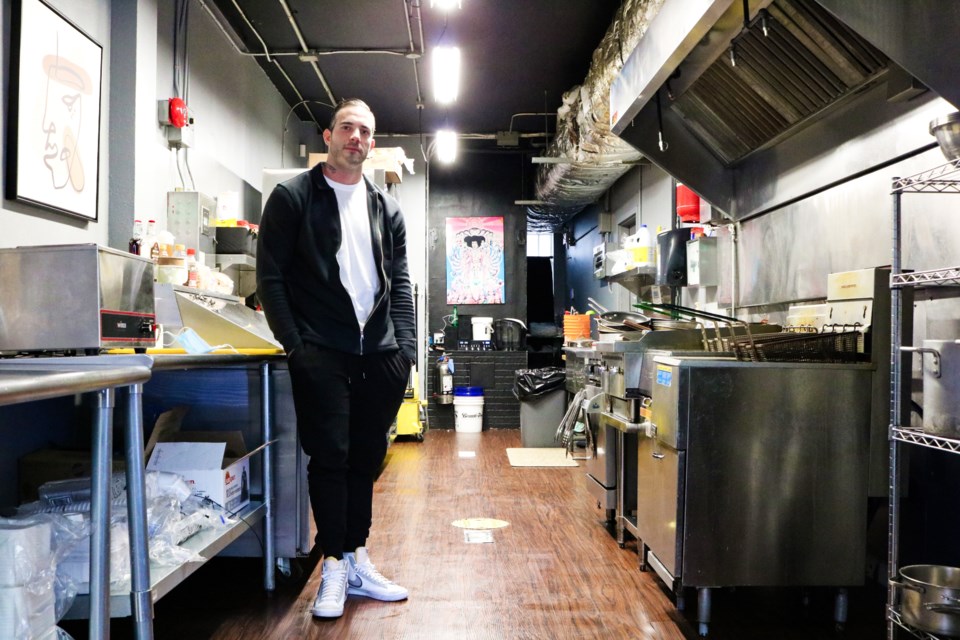 Owner Trevor Luchuk stands inside Lucky's Gourmet Comfort Food.