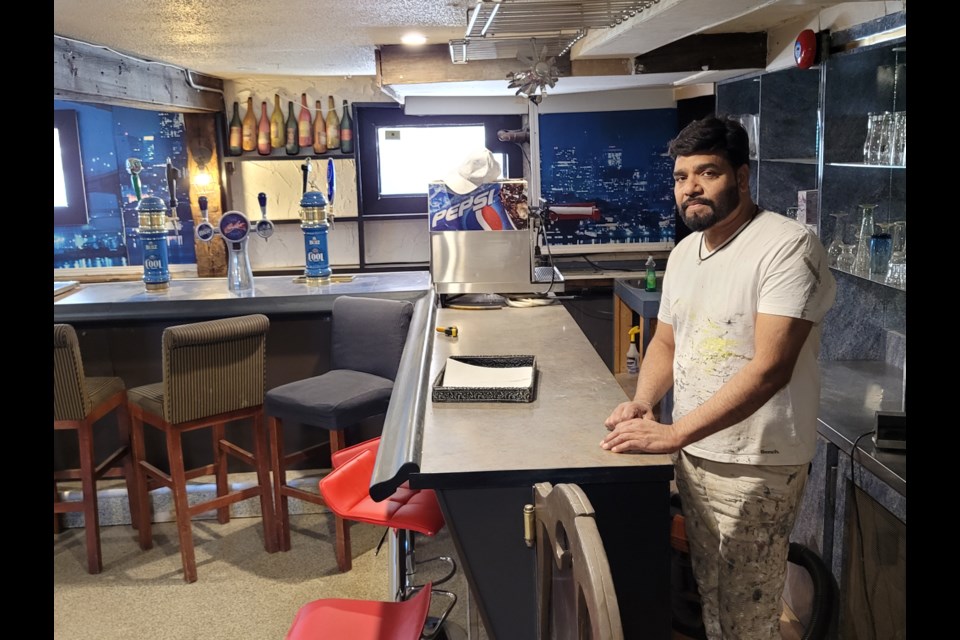 Surjit Jassal stands behind the bar  he's hoping to get open soon in the basement of Voodoo Wings.