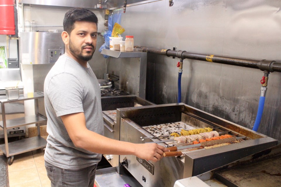 Co-owner of Kabob Grill, Ashraf Mulla, prepares kabobs for hungry customers.