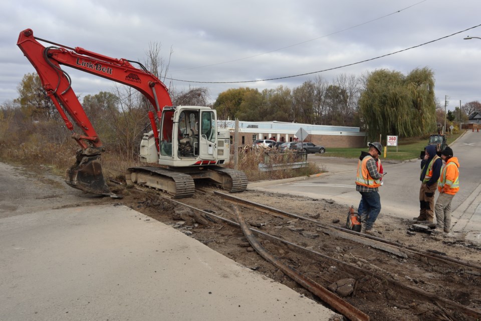 Contractors with CN Rail work to remove tracks on Montrose Street North on Tuesday.