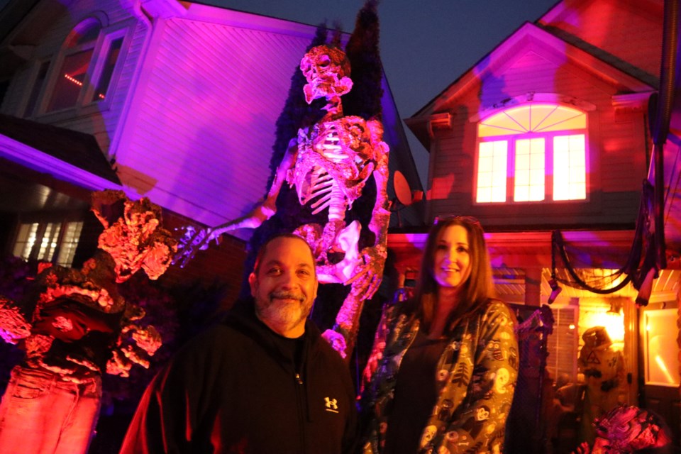 Jay and Natalie Schrier outside of their 355 Kerwood Drive home where they will be hosting a walk-thru haunted house on Oct. 31 and taking donations and supplies for the Cambridge Humane Society. 