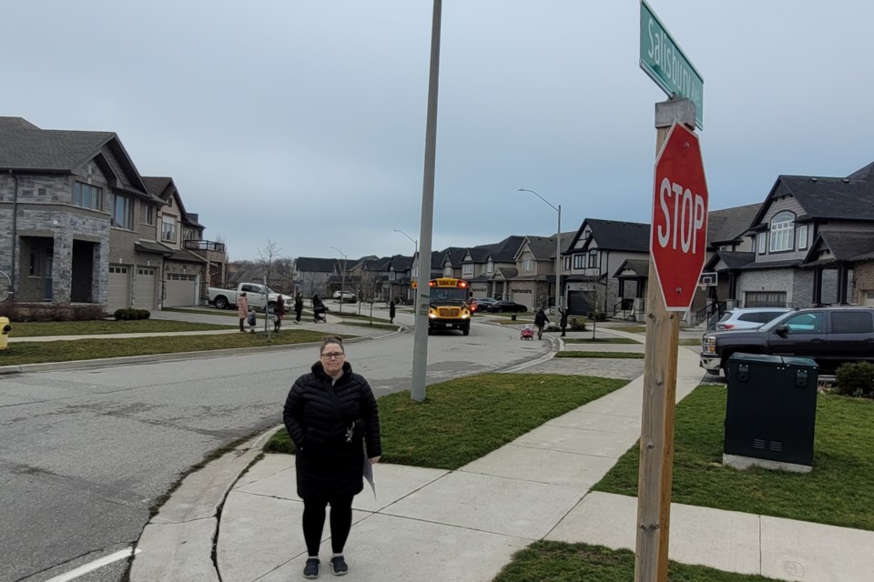 Teri Pfohl stands at the intersection of Salisbury Avenue and Hardcastle Drive where the city removed two stop signs in 2019. Residents in the area want the intersection returned to an all-way stop.