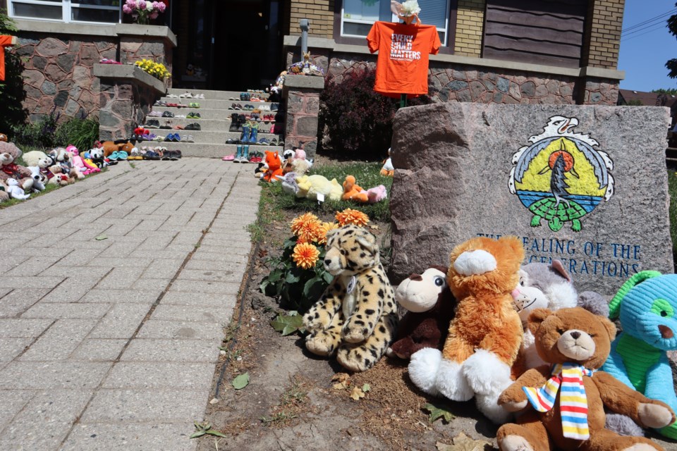 Teddy bears and shoes line the pathway and steps at The Healing of the Seven Generations First Peoples centre in Kitchener on Monday. The centre serves Indigenous communities in Waterloo region and surrounding areas.