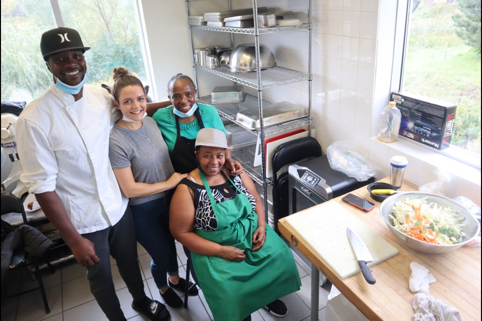 Theo Myrie, left, with his team in the kitchen at Irie Myrie's Caribbean Catering Company, Seayra Pacheco, his mom Doreen Evans, and his godmother Maxine Watson.