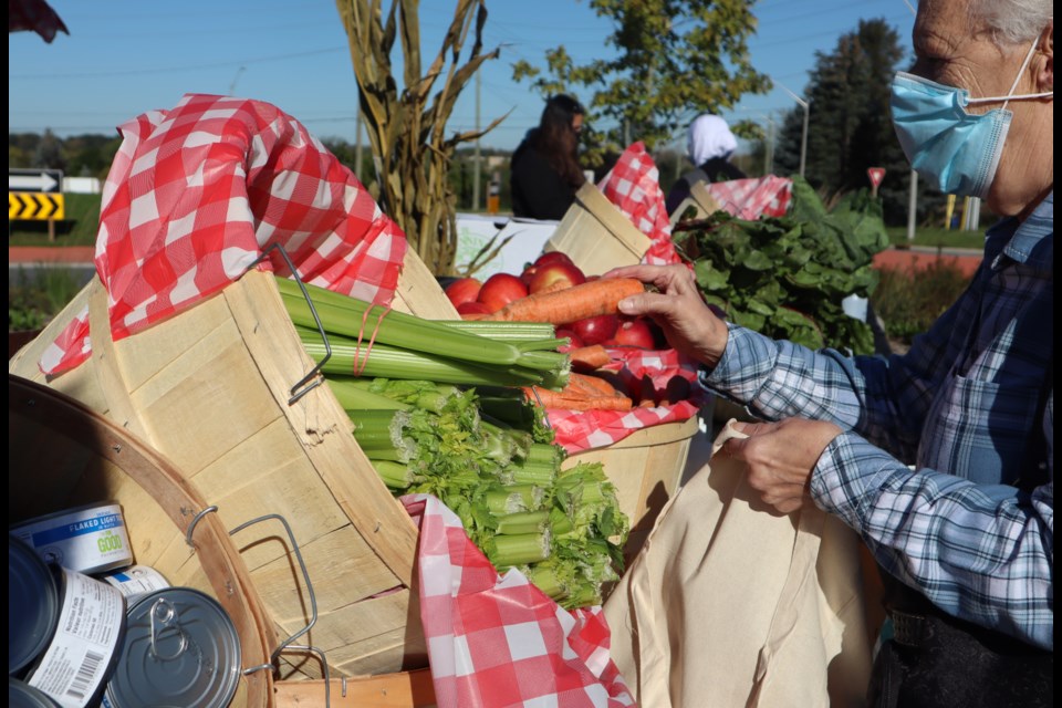 Fresh vegetables, non-perishables and honey were all on offer to anyone paying $5 at the Cambridge Food Bank's mobile food market at Forward Church on Tuesday.