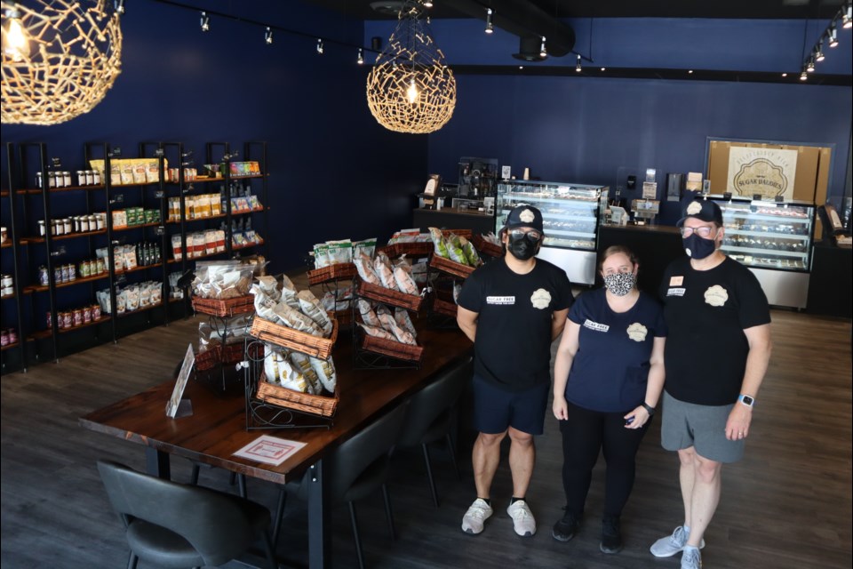 Sugar Daddies Bakery owners David Gardner-Orbon, left, and Greg Gardner-Orbon flank store manager Sara Chaisson at their new Main Street store in downtown Galt.