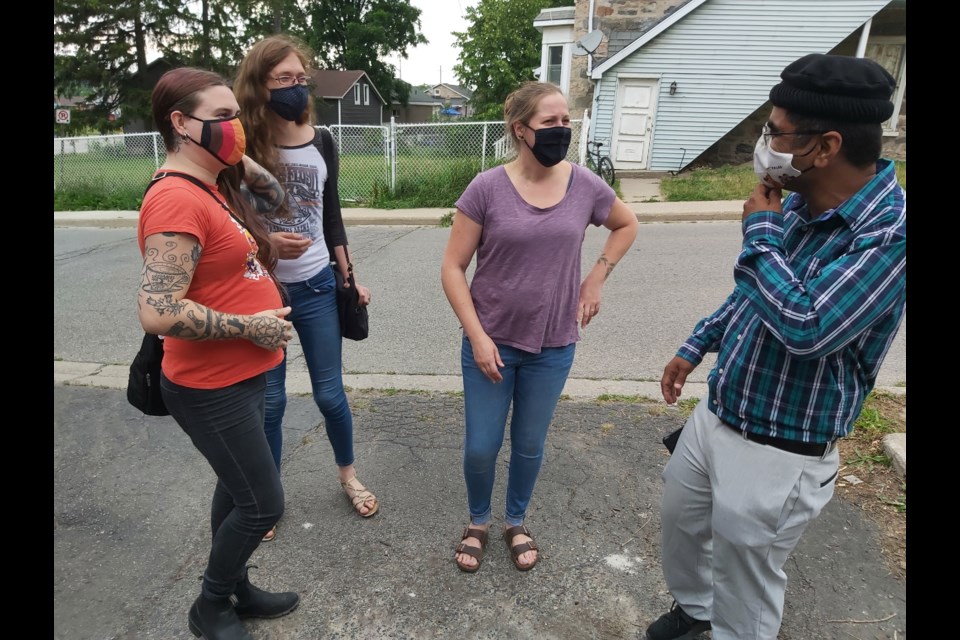Athena Van Nacht, Lilith Kummling, and Courtney Winkels were walking back home from work when they stopped in at the open house to chat with Nomaan Mubashir, president of the mosque.
