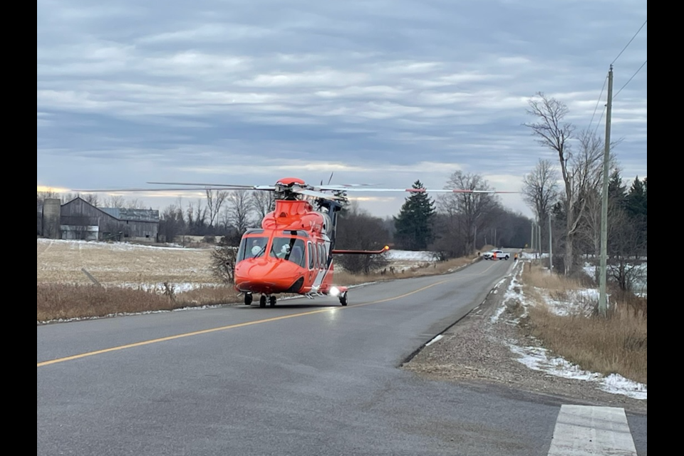 An air ambulance lands on Fife Road to transport an injured motorist Friday.