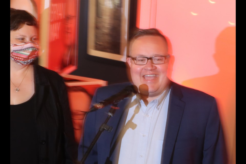 Bryan May, flanked by his wife Kristin, thanks his campaign team during a preliminary victory celebration at Piatto on Hespeler Road early Tuesday morning.