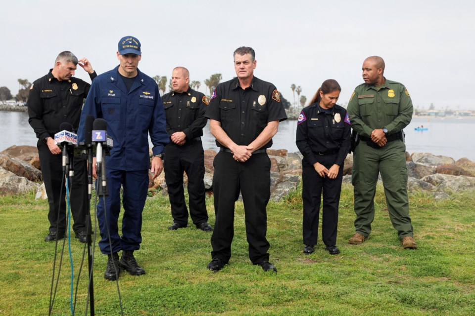 Representatives from the U.S. Coast Guard, U.S. Border Patrol, and San Diego Lifeguards prepare to speak to media members after two fishing boats capsized off the coast of San Diego. REUTERS/Sandy Huffaker