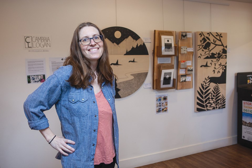 Cambria Logan, with meticulously-lined acrylic works at the Gibsons Public Market.