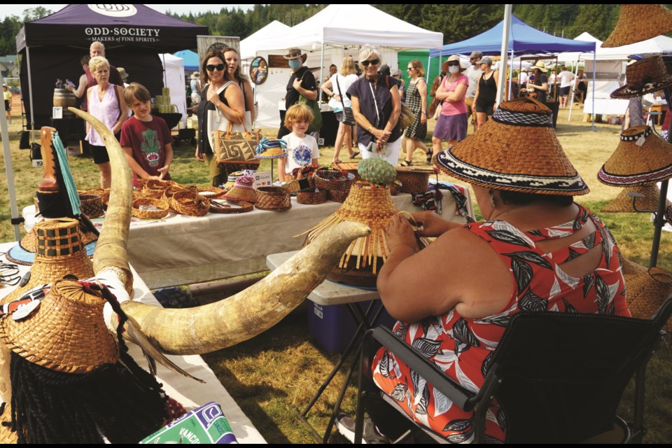 Cedar hat weaver Shy Watters attracted onlookers while she crafted more of her unique works. 