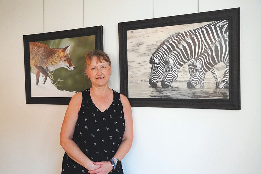 Artist Nadine Sallinen at Gibsons Public Market with two of her finely detailed pastel paintings.