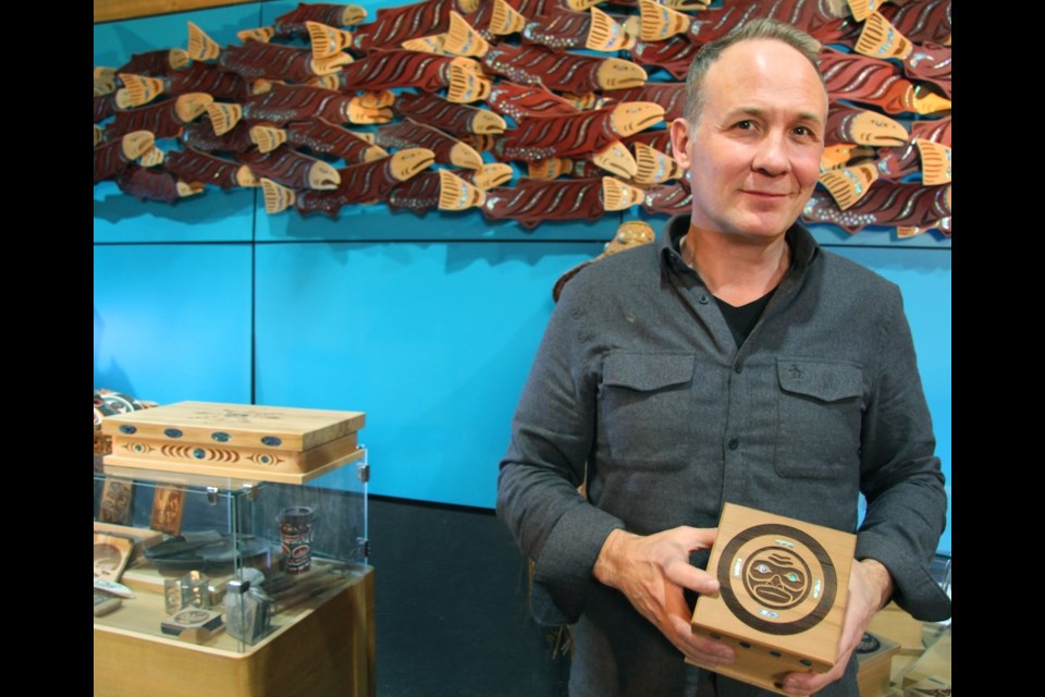 Shain displays one of the handmade, cedar bentwood boxes created at Spirit Works Ltd.