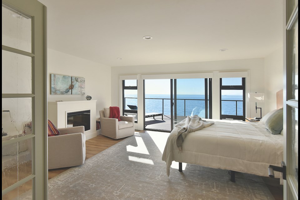 The master bedroom, with its own fireplace and deck area is light and airy.