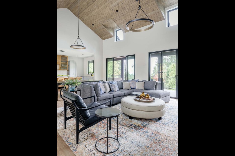 In the bright and airy living room, the sectional sofa is custom built with angled back support.