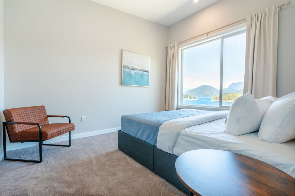 A bedroom with a view at West Coast Wilderness Lodge.