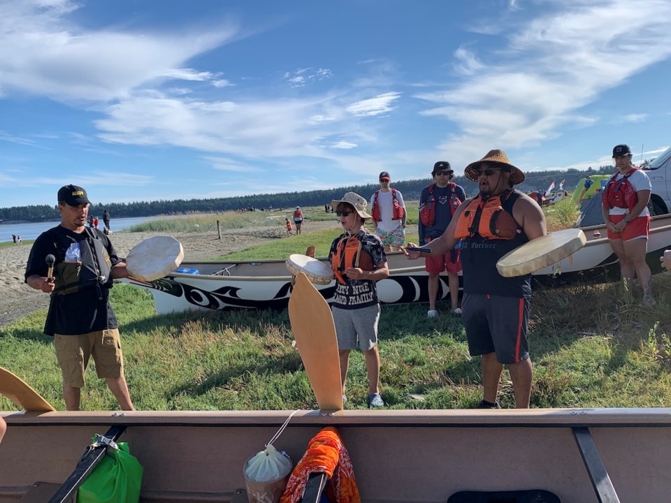 c-alfonso-salinas-right-drums-at-the-pulling-together-canoe-journey-before-launching-in-a-canoe-at-tsawout-first-nation