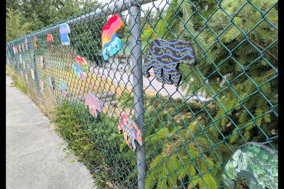Students from Kindergarten to Grade 7 transformed Kinnikinnick Elementary School’s front fence into a vibrant gallery of painted bears.