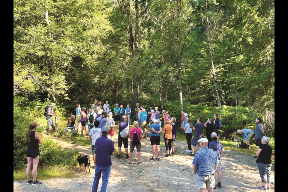 Group of Reed Road Forest walkers listen to leaders giving the forest’s historic background during a recent walk organized by ELF and Living Forest Institute.