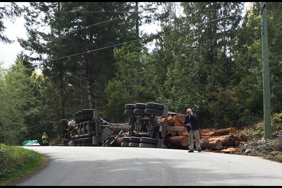 A logging truck tipped over at the corner of Egmont Road and Cod Lane, May 2. 