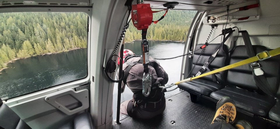 Volunteer in harness to be hoisted down to Gambier Lake