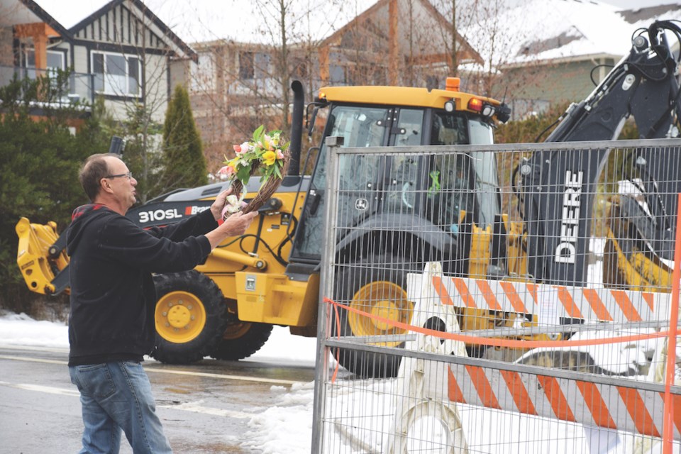 Feb. 15, 2019, former Seawatch resident Mike Paddison places a memorial wreath on the fencing that would bar public access to the subdivision. 