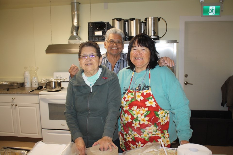 The smiling kitchen crew: Joyce Jackson, Herb August, and Lucy Joe.