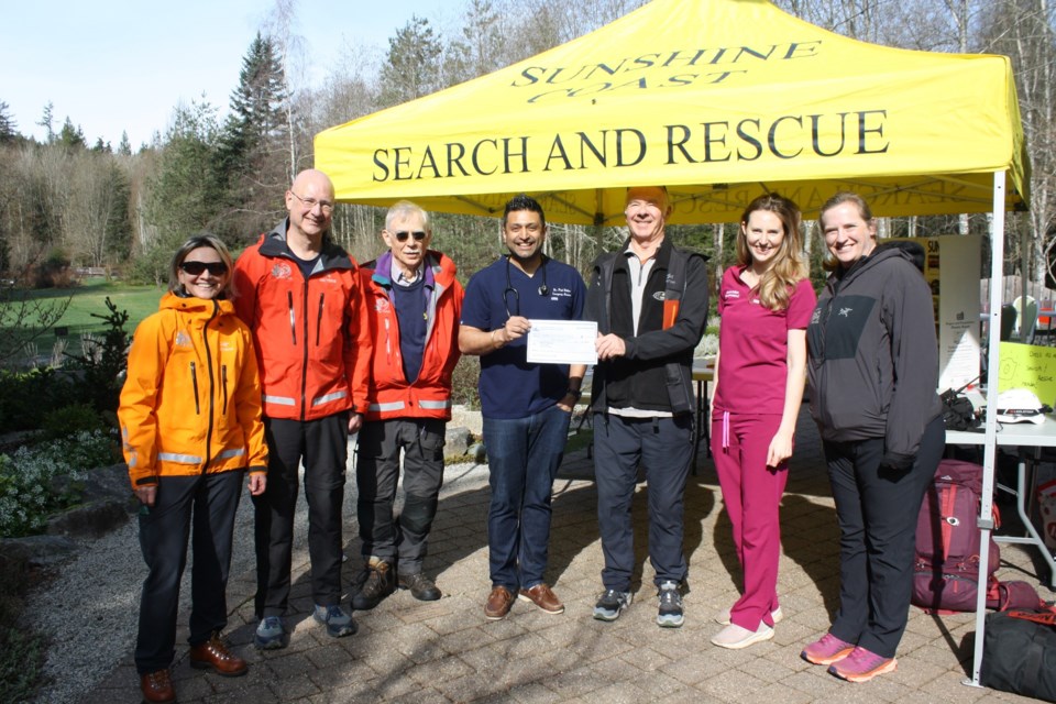 Dr. Paul Dhillon offered appreciation along with a cheque for $1,000 to Sunshine Coast Search and Rescue. From left are Natalia Kouznetsova, Stephen Smith, Rod Moorcroft, Dr. Paul Dhillon, Dave Steers, Sarah Dhillon, and Lindsay Noyes.