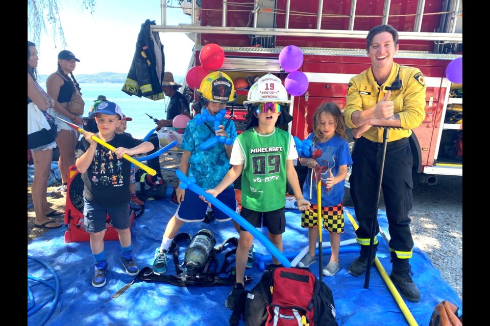 Firefighter Gregory Allcock, gave some firefighting tips to (l-r) Florian Haut-Labourdette, Alexander Beyrouty, Orlando Gray and Ezra Cloutier-Rintoul at the Halfmoon Bay Fair, July 14. 