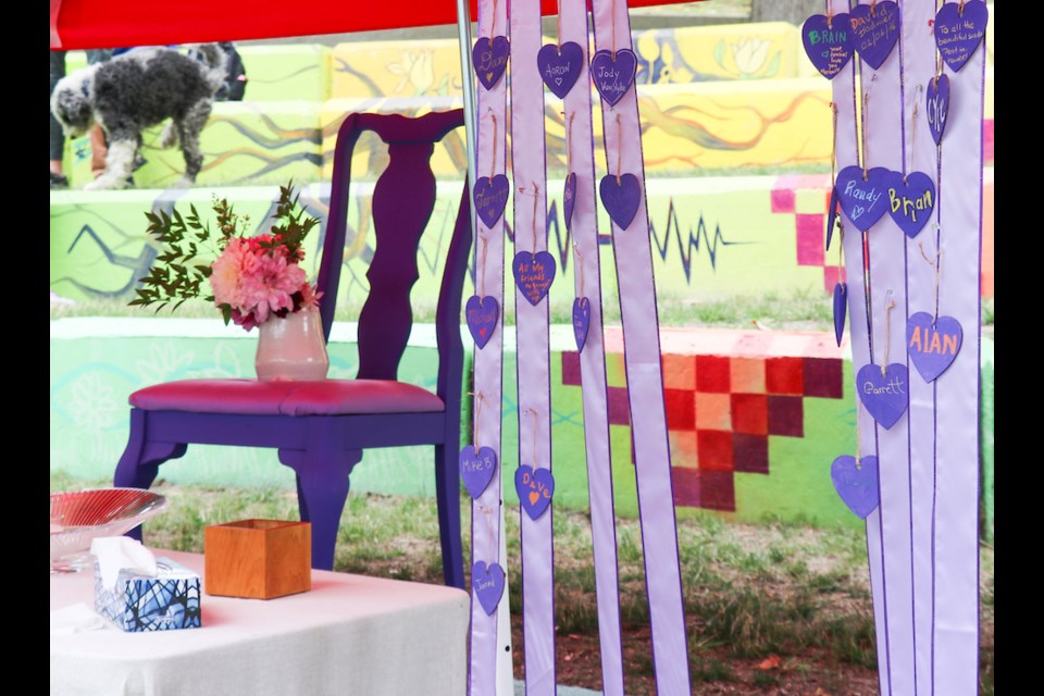 A chair on an altar and sashes bearing purple hearts were a memorial for loved ones who died from overdoses. 