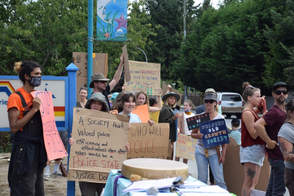 Around 50 people gathered outside the Sechelt RCMP detachment on Aug. 23 to protest recent police action against protesters at Fairy Creek.