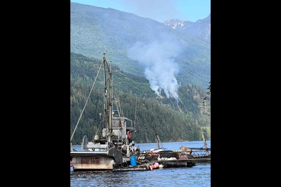 A small wildfire on the north side of Skookumchuck Narrows broke out July 14. Heather West captured this photo Thursday, with the “Tzoonie River” (the seiner belonged to Billy Griffith) in the foreground.