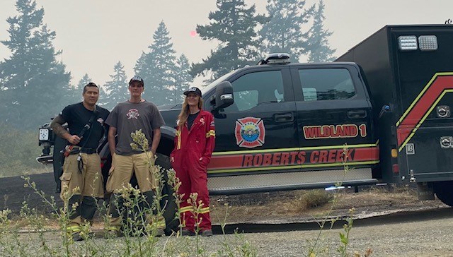 Sunshine Coast firefighters, Deputy Chief Sean Hatanaka, Lieutenant Russell Monkman and Ivy Lock Infront of the XRCVFD Wildland truck.