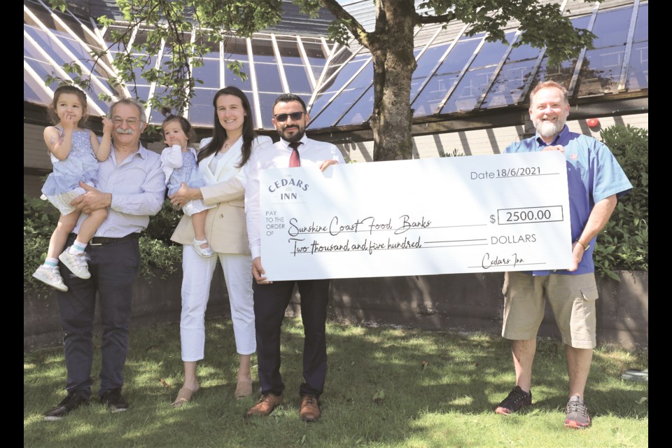 Darrel Pilgrim of the Salvation Army in Gibsons (right) receives a donation of $2,500 on behalf of the Coast Wide Food Bank Fund from the Cedars Inn Hotel team’s Hugo Lopez, Vincenza Thanas and Mario Laudisio. 