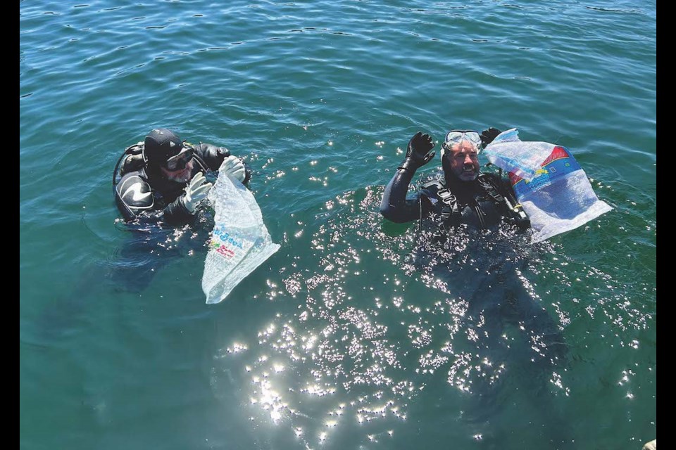 Volunteer diver collecting underwater debris at Irvines Landing.