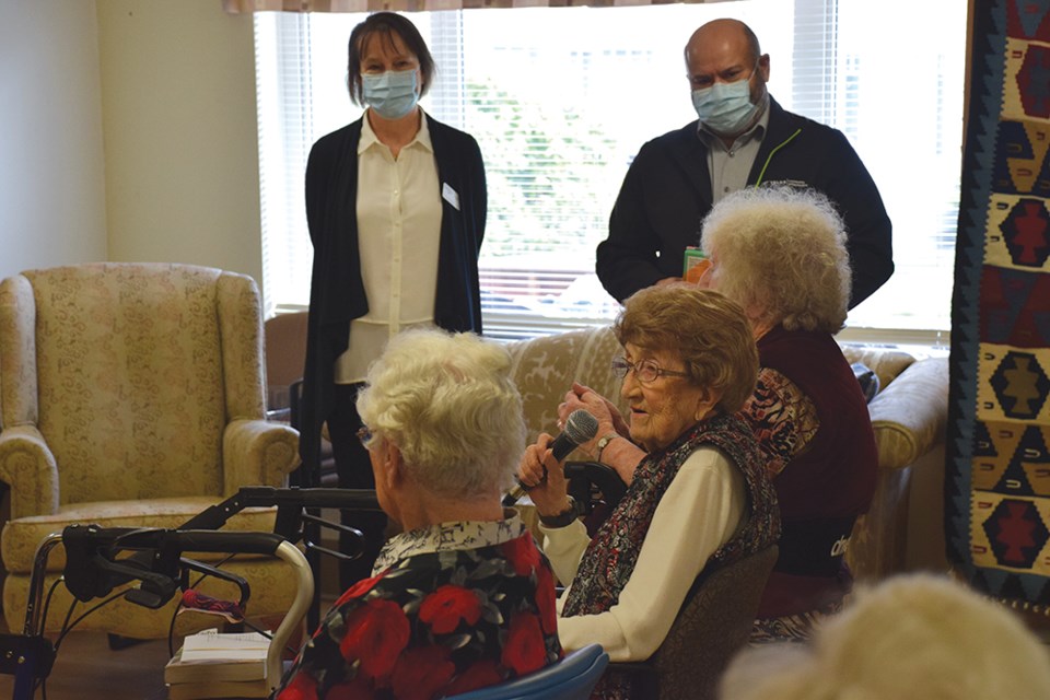 Christenson Village resident Cervia Nutbrown thanks Sue Larose-Cloherty and Manjit Kang for helping the residents access books.