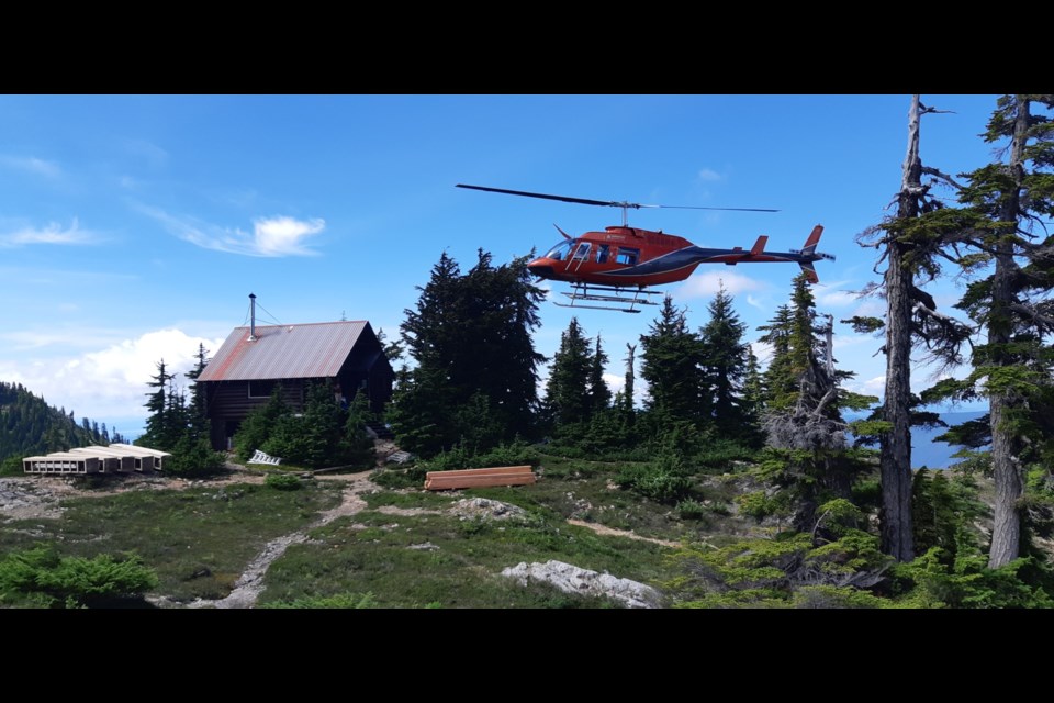 Helicopter coming in to land at the yet-to-be re-roofed Steele cabin. 