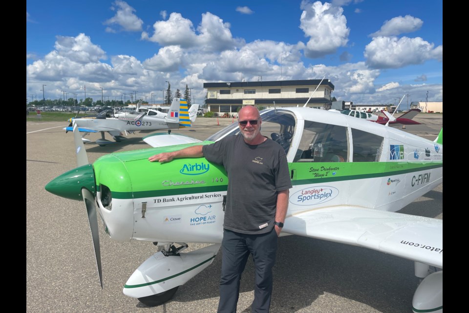 On the ground at Fort St. John, Steve Drinkwater poses with his Piper Cherokee 140.