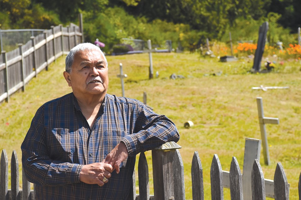 Hiwus (Chief) Warren Paull stands at the cemetery on shíshálh Nation lands, located near the now-closed Our Lady of Lourdes Mission Church. Students who died at Sechelt Residential School are buried at the cemetery. 