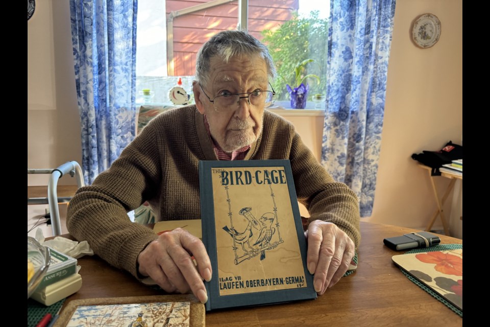 Sechelt resident Tony Price holds a copy of the book detailing life in the  POW camp where he spent years during the Second World War.