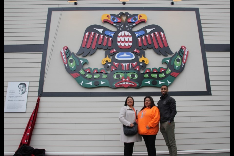 Alvina, Jillena and Jamal Paul pose for a photo at the unveiling of artwork by ?antuni Tony Paul, the late master carver, on June 16.
