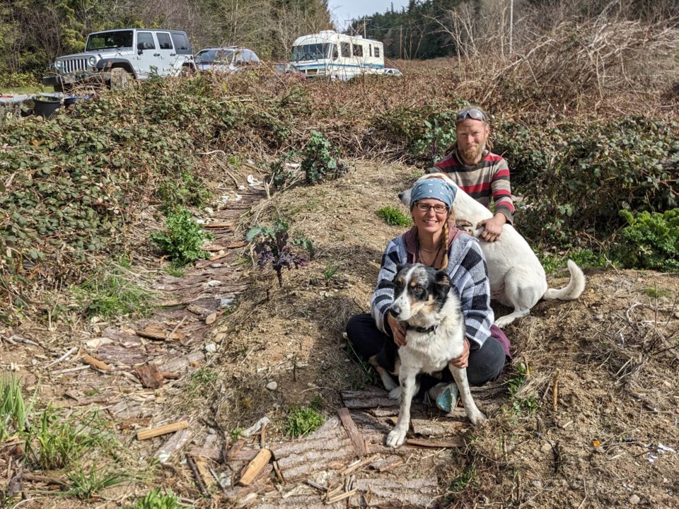 two-people-in-a-garden-in-spring-with-two-dogs